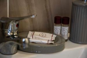 a sink with a faucet and two candles on a counter at Blu Mare Lampedusa Bed And Breakfast in Lampedusa