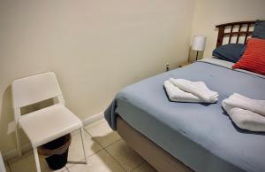 a bedroom with a blue bed and a white chair at Cozy rooms in cute house, close to Miami airport - Free parking in Miami