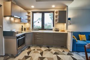 a kitchen with a blue couch in a room at Apartmán u Martina in Jablonec nad Nisou