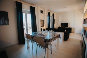 a living room with a dining room table with chairs at Principato di Baragallo - Free Private Parking in Sanremo