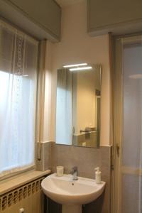 a bathroom with a sink and a mirror at B&R Apartment in Caselle Torinese