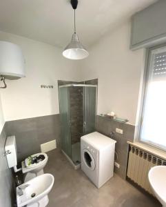 a bathroom with a toilet and a shower and a sink at B&R Apartment in Caselle Torinese
