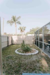 a garden with a plant in the middle of a house at Entire home, heated pool, just 10 min to beach! in Vero Beach