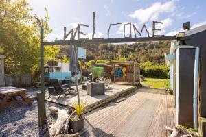 a patio with a sign that says winime at Brunnerton Lodge and Backpackers in Greymouth