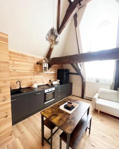 a kitchen with a table in the middle of a room at LouLou Home's in Antwerp