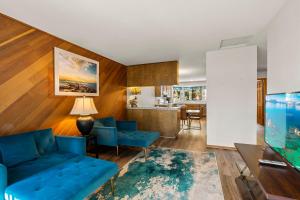 a living room with blue couches and a kitchen at 1 Sky Lake - walk to town in Incline Village