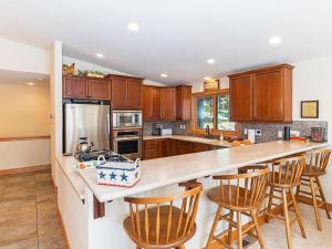 a kitchen with wooden cabinets and a counter with bar stools at Amazing mountain setting in Incline Village