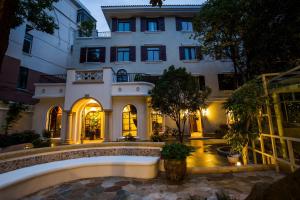 a large white building with a courtyard in front of it at Shanghai Soho Garden Hotel in Shanghai