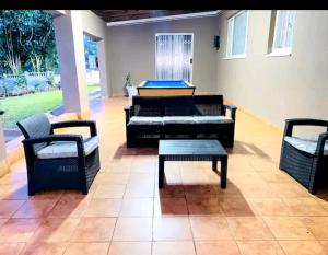 a living room with couches and a table and chairs at Listos Guest House in Empangeni