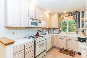 a kitchen with white cabinets and a stove top oven at 107 McCloud - Highly Sought After Complex in Incline Village