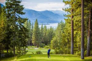 a man is playing golf on a golf course at 107 McCloud - Highly Sought After Complex in Incline Village