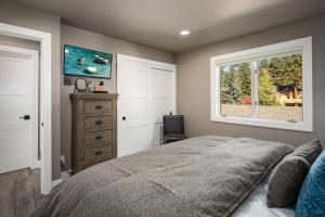 a bedroom with a bed and a window and a dresser at 128 McCloud - Luxury Couples Retreat in Incline Village
