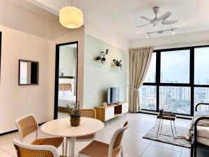 a living room with a table and chairs at Urban Suite Cozy Family Homestay at Georgetown by Heng Penang Homestay in Jelutong