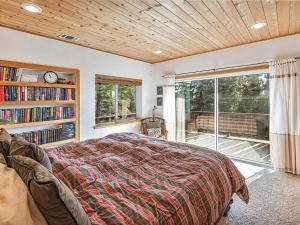 a bedroom with a bed and a book shelf at Fantastic Lakeview house with large decks! in Incline Village