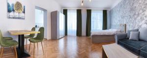 a living room with a couch and a table and a bed at Studio Excelsior 1 in Sibiu