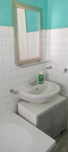a white bathroom with a sink and a mirror at Tita comfortable home in Johannesburg