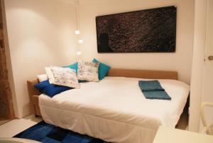 a bedroom with a bed with blue pillows on it at Blue Home in Santiago de Compostela