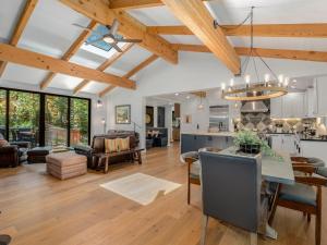 a large kitchen and living room with wooden ceilings at Modern Millcreek Home in Incline Village