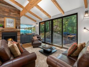 a living room with leather furniture and a fireplace at Modern Millcreek Home in Incline Village