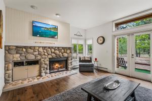 a living room with a fireplace and a tv at 153 McCloud The perfect location! Enjoy the sun drenched deck in Incline Village