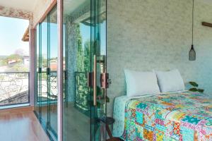 1 dormitorio con 1 cama y puerta de cristal en CASA SPA Pirenópolis casa inteira en Pirenópolis