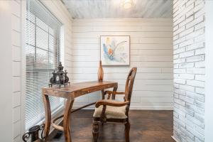 a home office with a wooden desk and a chair at Colleens Corner Captivating 4bed 2.5 bath in Charming Neighborhood in Little Rock