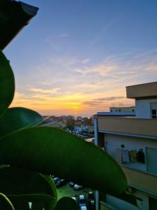 a view of a sunset from the balcony of a building at Ostia Sunset in Lido di Ostia