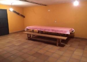 a room with a table with a pink covering on it at LOS MIRLOS in Navaluenga