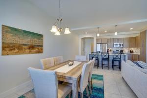 a dining room and kitchen with a table and chairs at Modern Fort Myers Condo Rental about 5 Mi to Beach! in Fort Myers