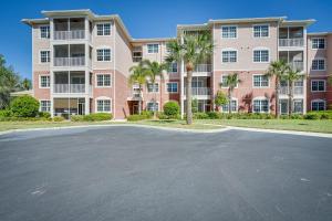 an empty parking lot in front of a large building at Modern Fort Myers Condo Rental about 5 Mi to Beach! in Fort Myers