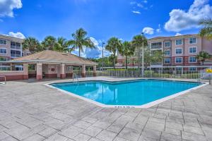 a swimming pool in front of a building at Modern Fort Myers Condo Rental about 5 Mi to Beach! in Fort Myers