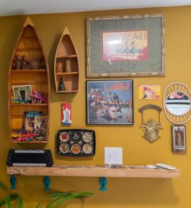 a shelf on a wall with pictures on it at Tropical Tiki Hut in Louisville