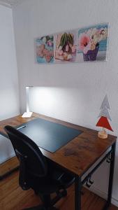 a desk with a chair and a lamp on it at Casa do Freire - Serra da Estrela in Aguincho