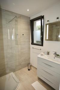 a bathroom with a shower and a sink and a mirror at Eze Villa in Èze