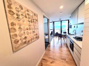 a kitchen with a painting on the wall at 309 Waterfront in Werribee South