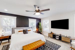 a bedroom with a large bed with a ceiling fan at Liberty Manor in Jacksonville