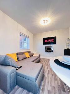 a living room with a couch and a table at Ava's Apartment - 1 Bedroom In Solihull Centre - Free Parking - Wi-Fi in Solihull