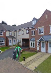 a house with a playground in front of it at Ava's Apartment - 1 Bedroom In Solihull Centre - Free Parking - Wi-Fi in Solihull