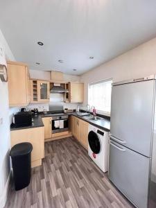 a kitchen with a refrigerator and a dishwasher at Ava's Apartment - 1 Bedroom In Solihull Centre - Free Parking - Wi-Fi in Solihull
