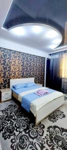 a bedroom with a large bed in a room at Жк Нурсая 2комн.апартаменты in Atyrau