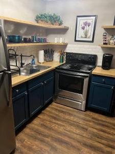 a kitchen with a sink and a stove at Indigo DowntownWalkable KingBed in Raleigh