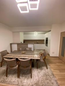 a dining room with a large wooden table and chairs at Violin 2 bedroom Apartment downtown Prizren in Prizren