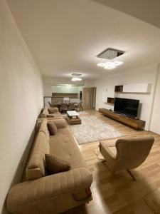 a large living room with a couch and a television at Violin 2 bedroom Apartment downtown Prizren in Prizren