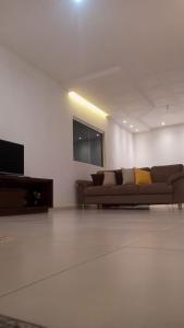 a living room with a couch and a flat screen tv at Casa - Aluguel por temporada in Garanhuns