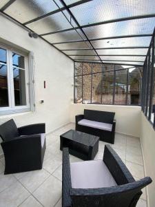 a patio with couches and chairs and a table at Gîte à la ferme in Viserny +29 photos