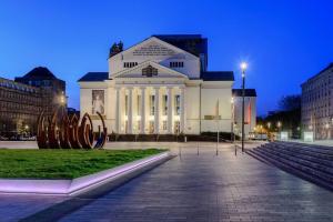 a large white building with a sculpture in front of it at - 3-Bedroom Apartment Luxury: Central & Spacious in Duisburg & Big TV and Kitchen - in Duisburg