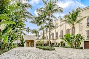 an exterior view of a building with palm trees at Marco Beach Ocean Resort 1202 in Marco Island