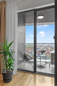 a living room with a hammock on a balcony at The Address Bucharest in Bucharest