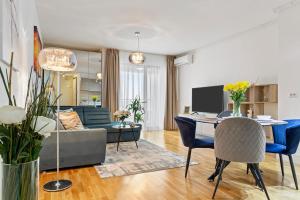 a living room with a couch and a table at The Address Bucharest in Bucharest