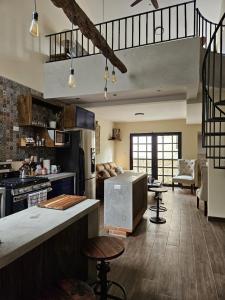 a large kitchen with a counter and a stove at Loft Candelaria Antigua in Antigua Guatemala